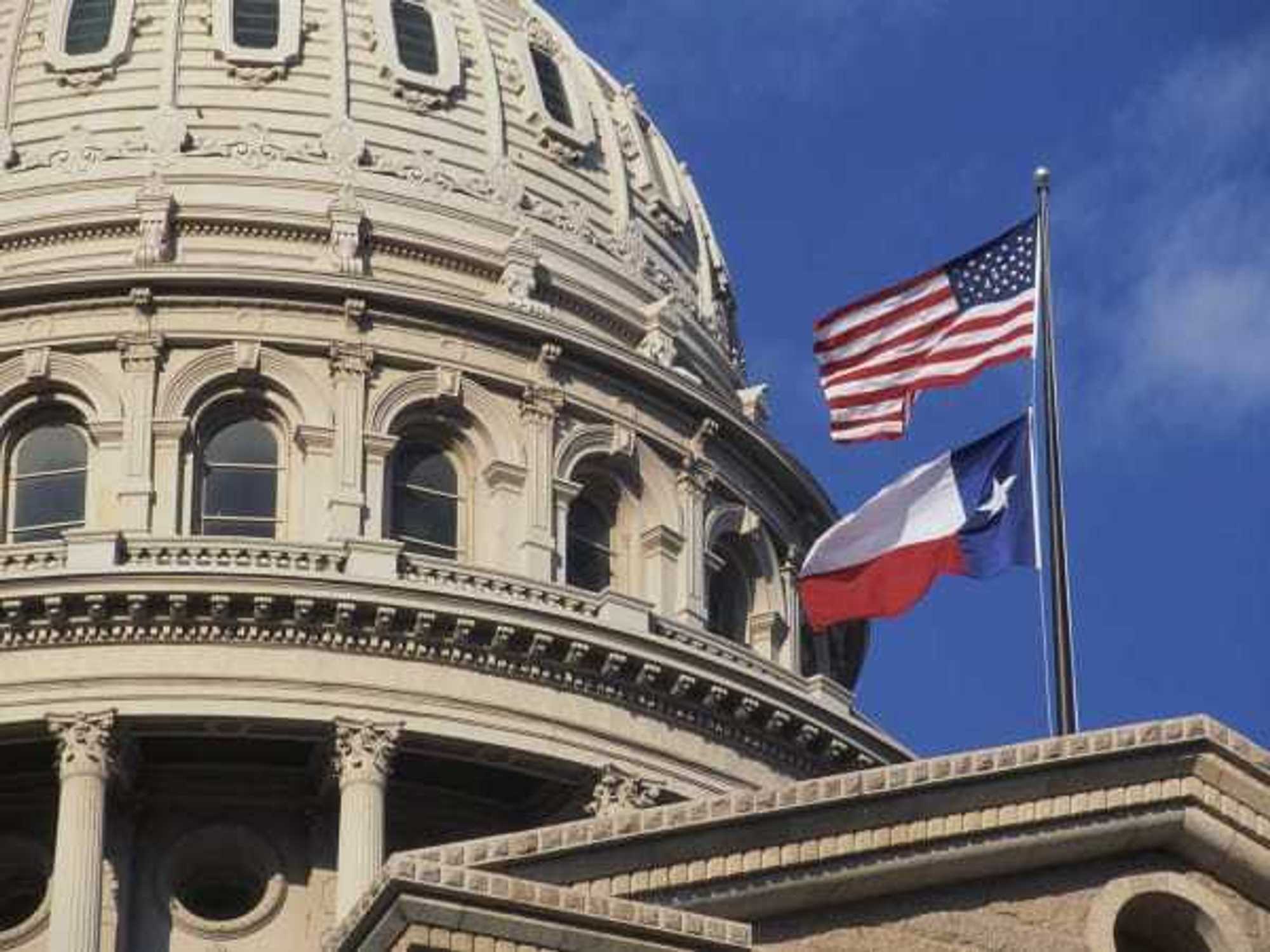 Texas Capitol with state and US flags