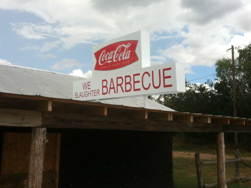 https://dallas.culturemap.com/media-library/texas-chain-saw-massacre-gas-station-we-slaughter-barbecue-restaurant-resort-sign.jpg?id=31653215&width=980