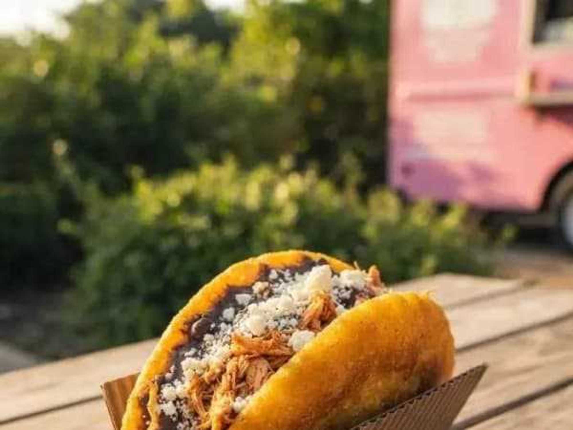 The central Venezuelan variation of empanadas is fried whole before being sliced open to hold additional fillings and toppings.