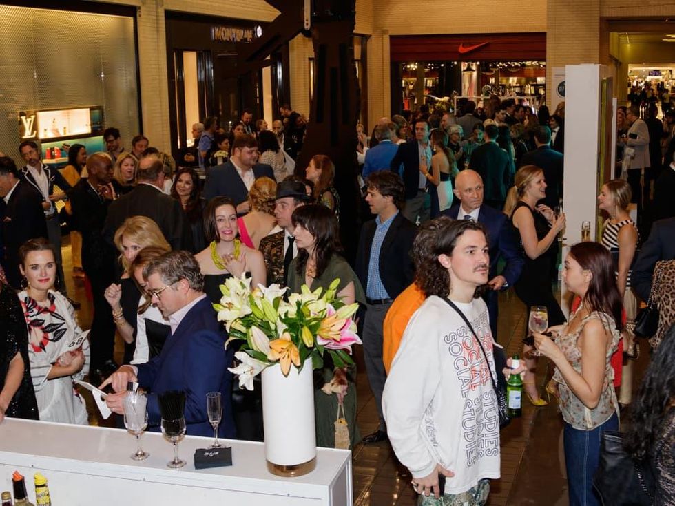The crowd milled among luxury shops during the cocktail hour