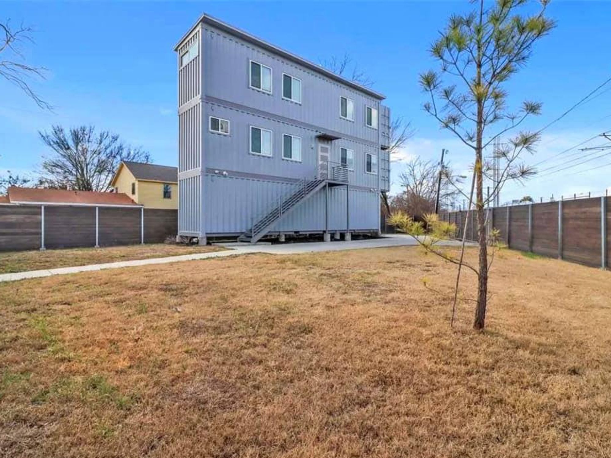 Three-story shipping container house cuts a sharp profile.