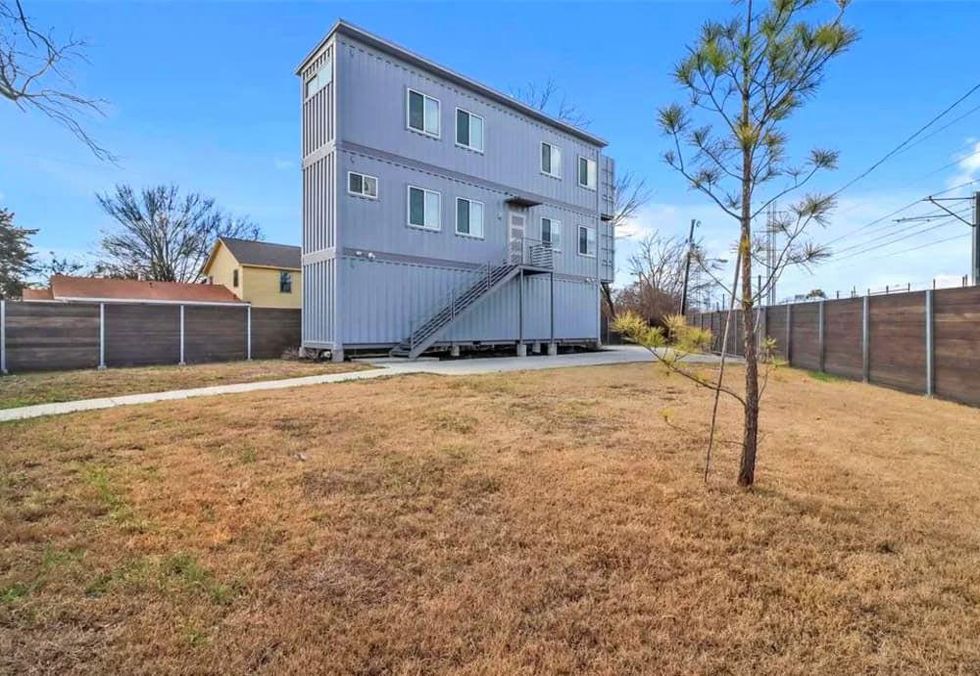 Three-story shipping container house cuts a sharp profile.