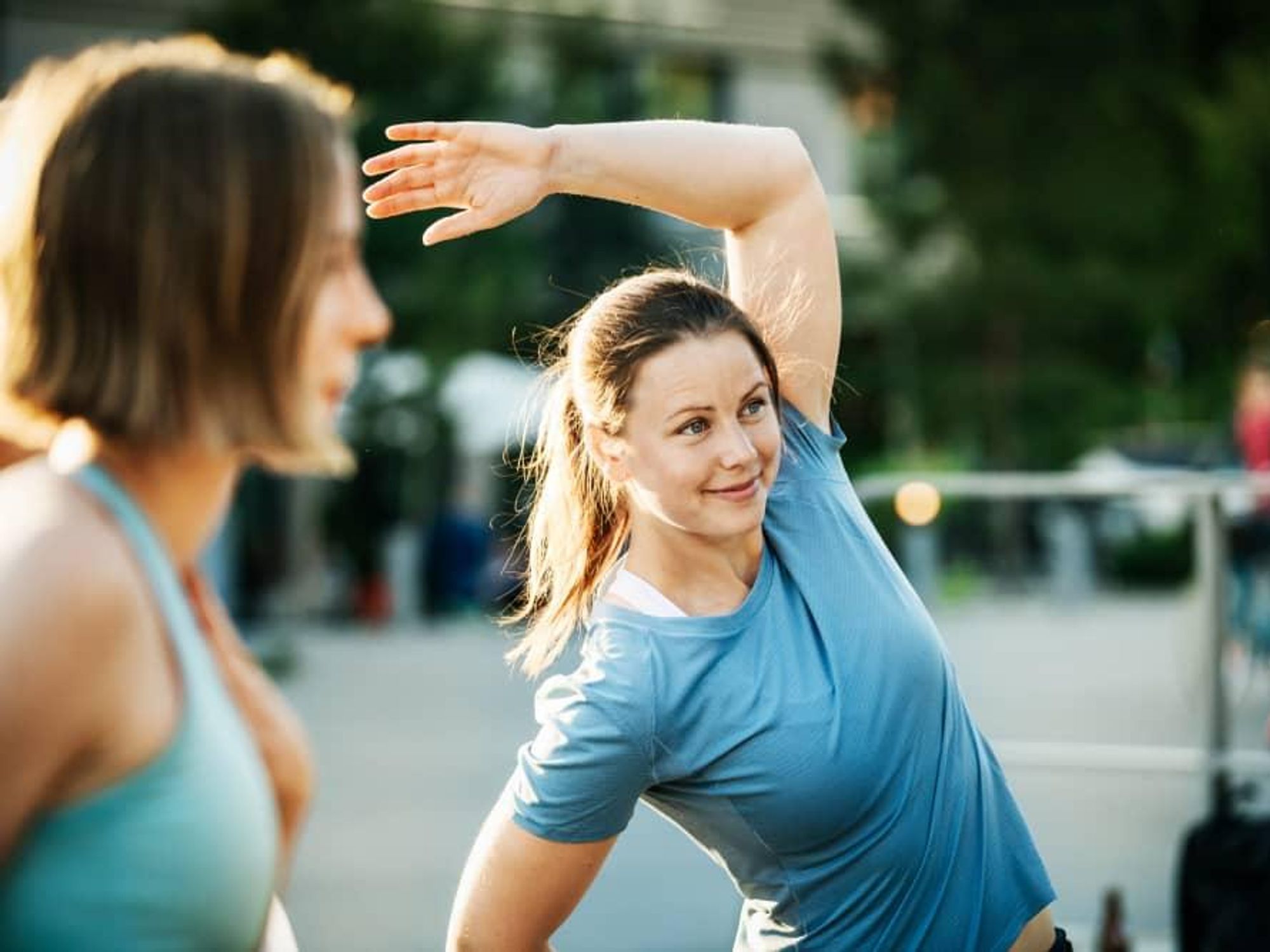 Two women warming up to work out