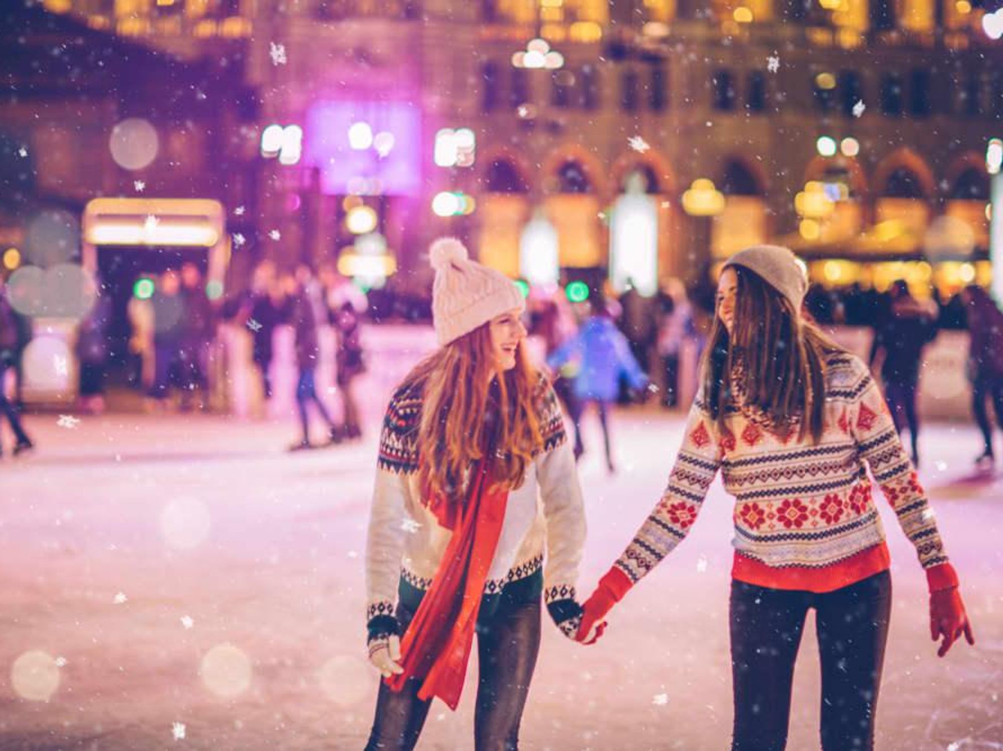 Two young women ice skating