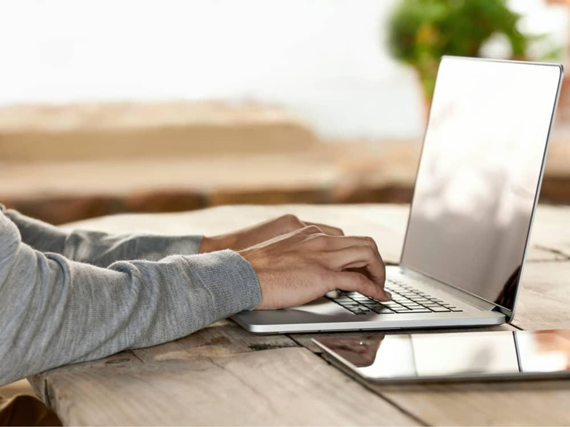 Typing at a laptop computer