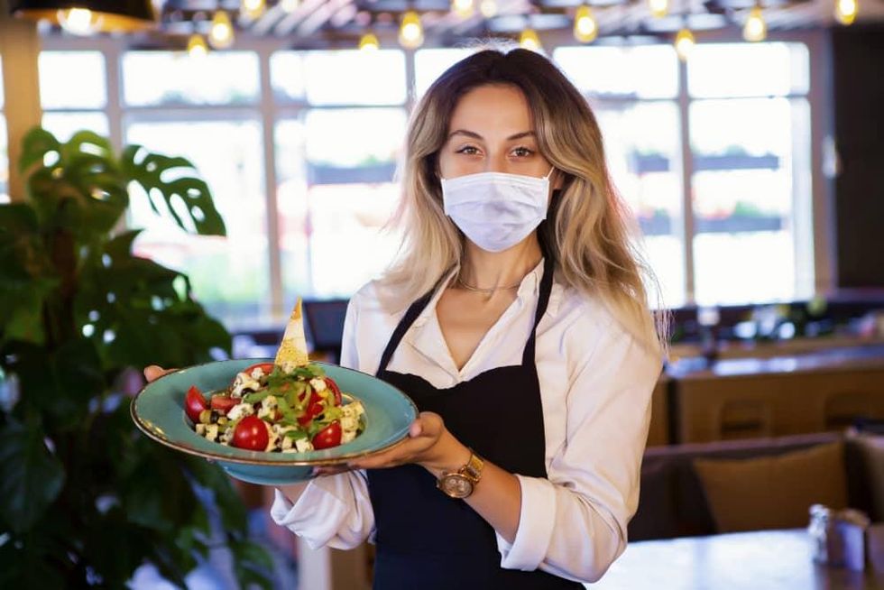 waitress wearing mask at restaurant