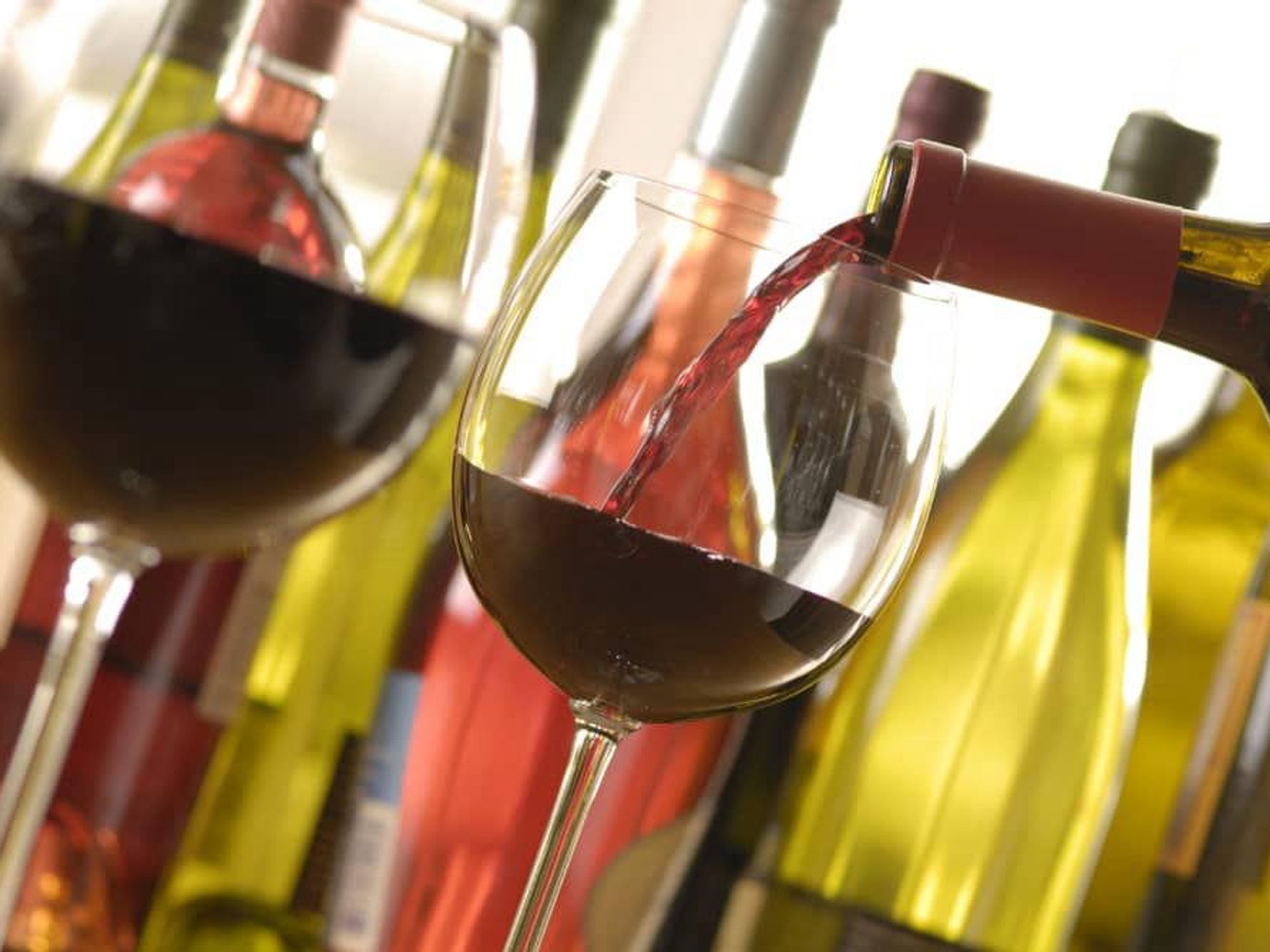 wine glasses pouring wine bottles of wine