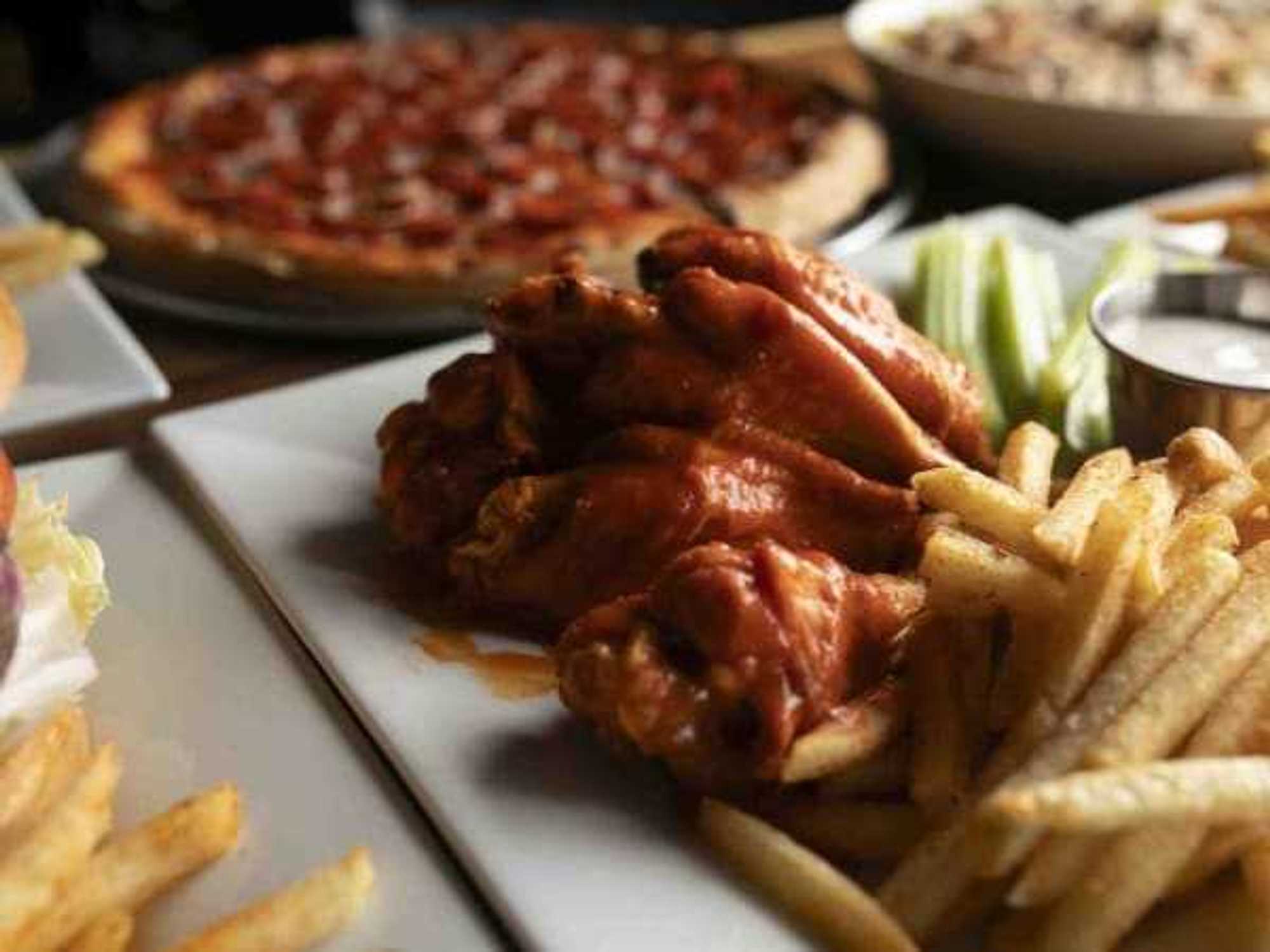 Wings and fries from the all-day menu at Charlie’s Tavern & Kitchen, opening this Saturday in Lake Highlands.