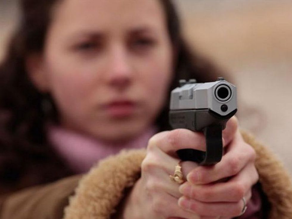 Woman aims her gun