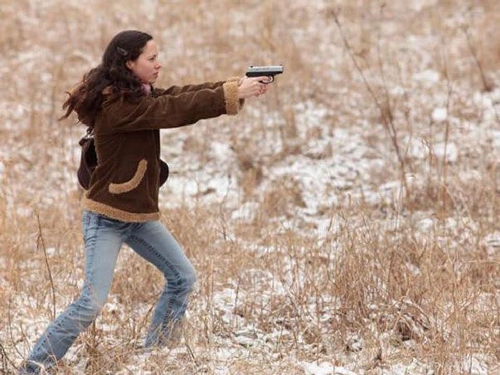 Woman aims her gun