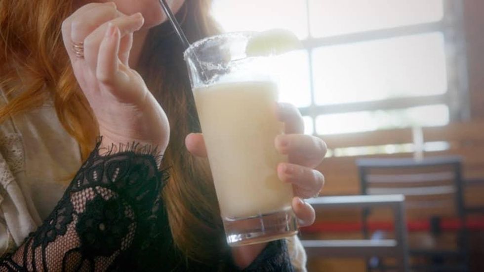 Woman drinking a margarita