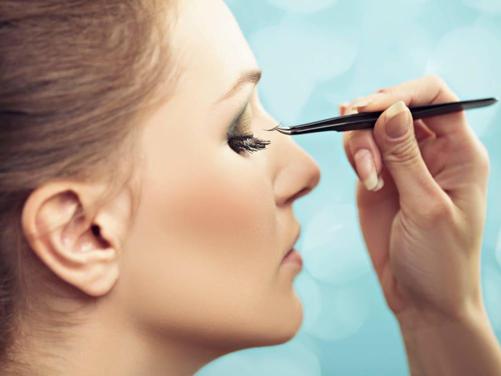 Woman getting eyelash extensions