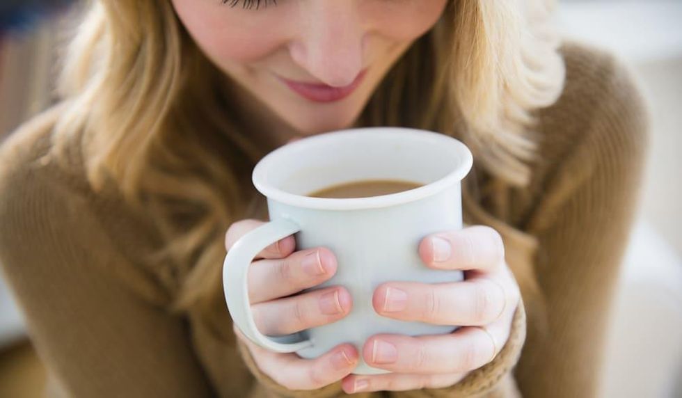 Woman holding a cup of coffee