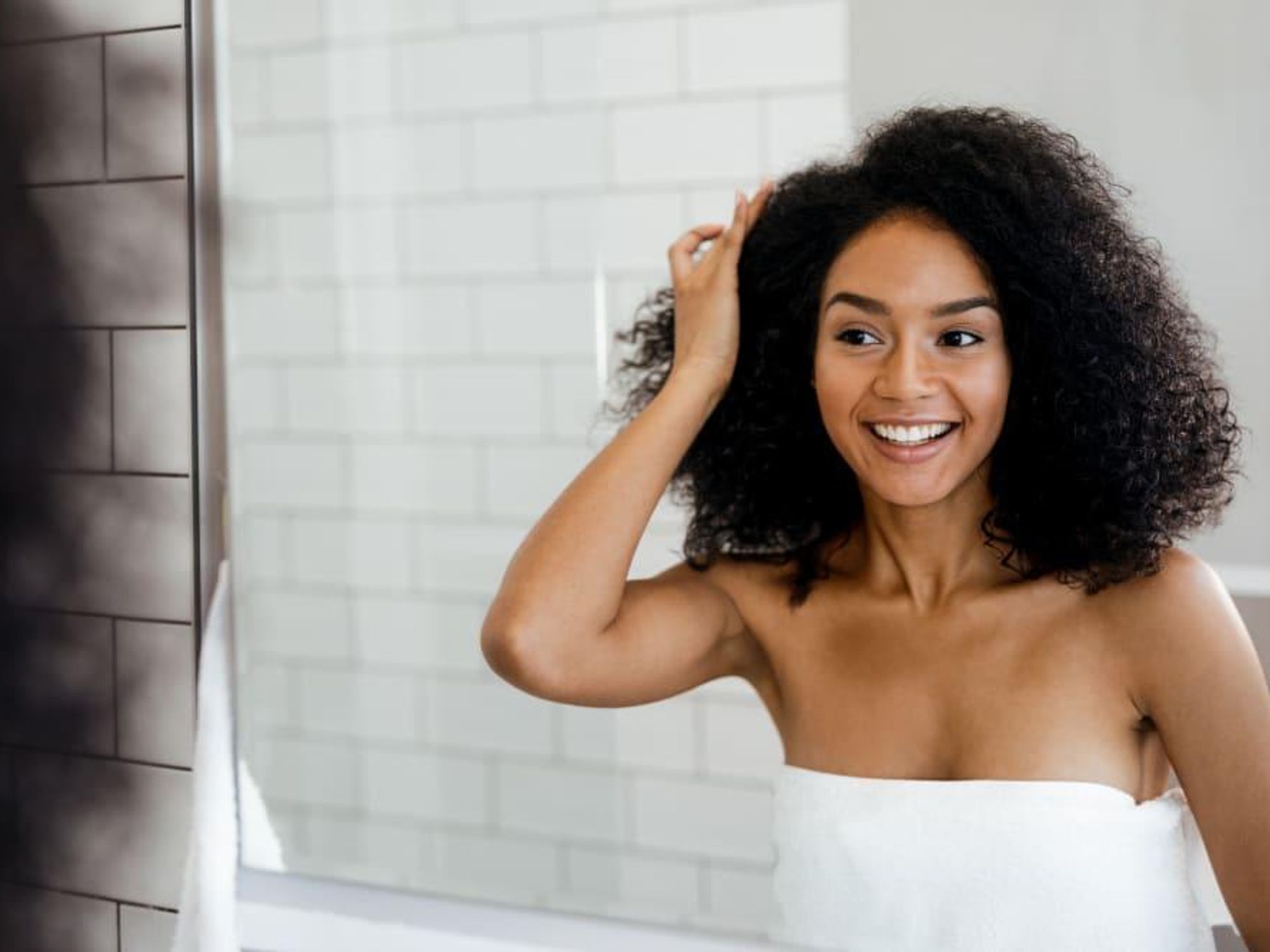 Woman looking in bathroom mirror