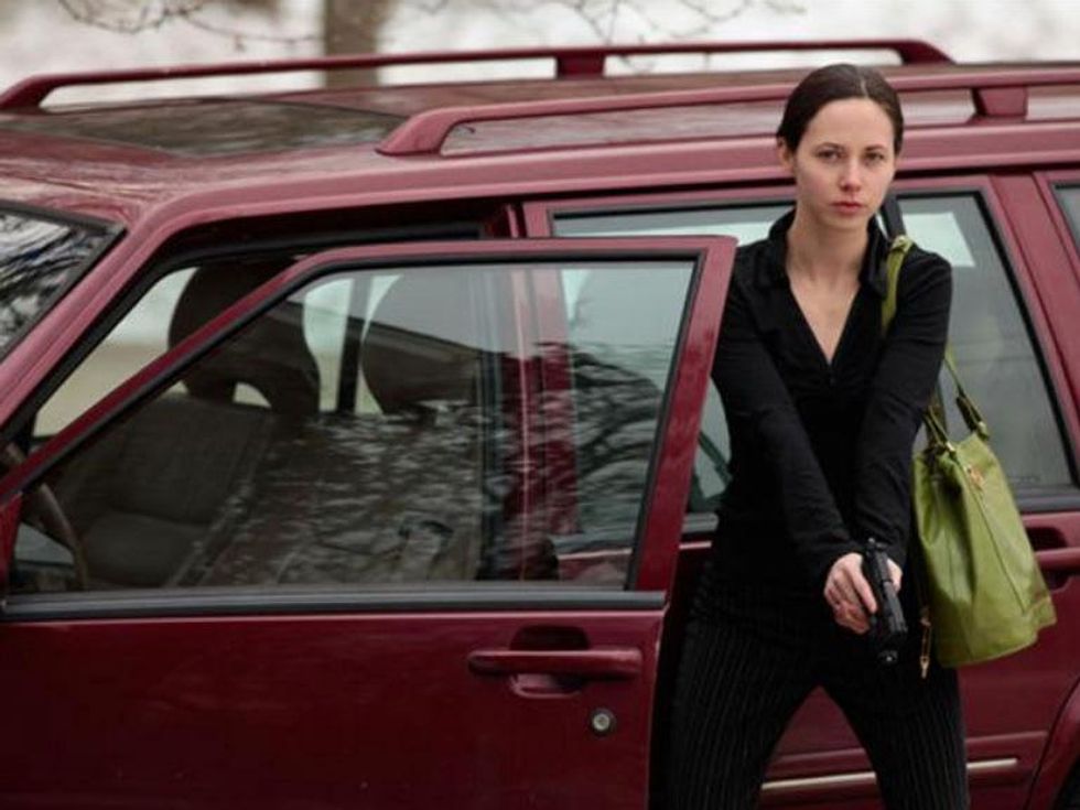 Woman prepares to shoot her gun