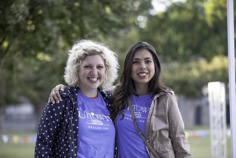 Women smiling while wearing Uptown Dallas T-shirts